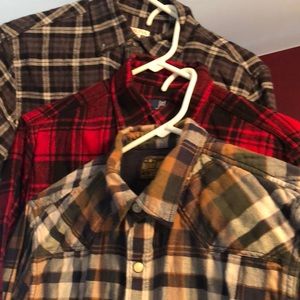Bundle of three flannel shirts.